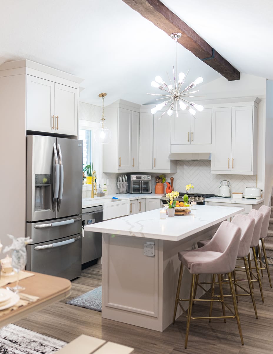 Custom kitchen renovation with waterfall island and chandelier